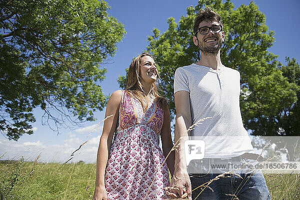 Happy mid adult couple walking in the countryside  Bavaria  Germany
