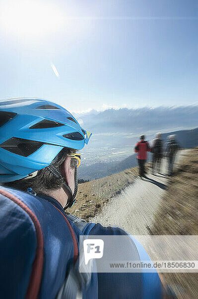 Mountain biker riding on track through mountain  Tirol  Austria