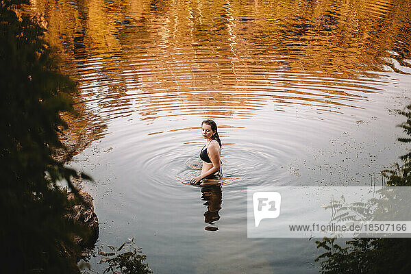 Young woman in a bikini standing in lake