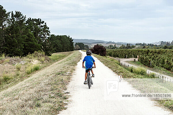 Tween boy riding a bike through the countryside
