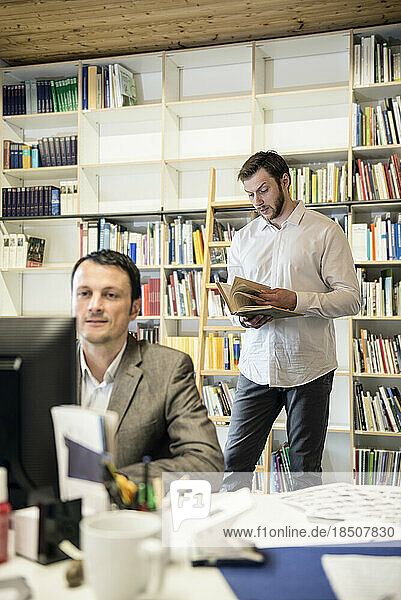 Two businessmen working in an office  Bavaria  Germany