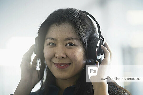 Young woman listening to music with headphones  Freiburg im Breisgau  Baden-Württemberg  Germany