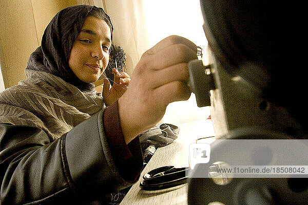In the workroom of an Afghan designer  a young woman works on an electric sewing machine in Kabul  Afghanistan.