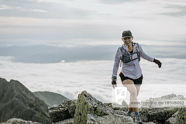 female hiker walks among rocks at summit of Mount Katahdin  Maine