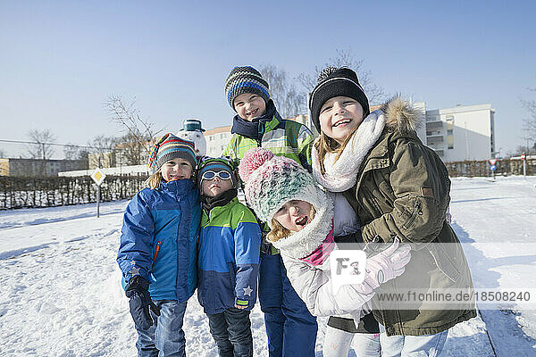 Portrait of children on snow field