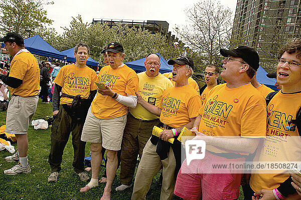 A group of men sing songs of encouragement to walkers at the Avon Walk for Breast Cancer in Boston.