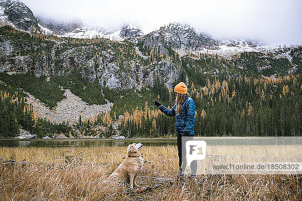 Female hiker and her dog in the north cascade mountains