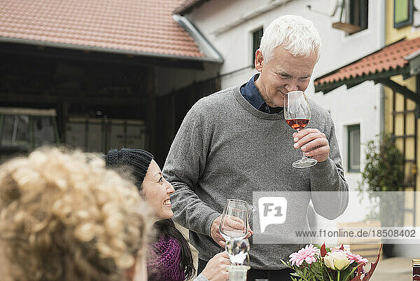 Mature man tasting wine during picnic at farmhouse  Bavaria  Germany