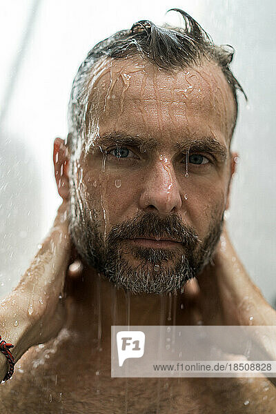 Middle-aged man in the shower  drops of water.