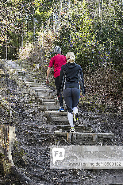 Couple doing training on stairs in nature
