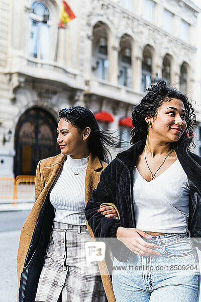 stock photo of two happy friends visiting the city
