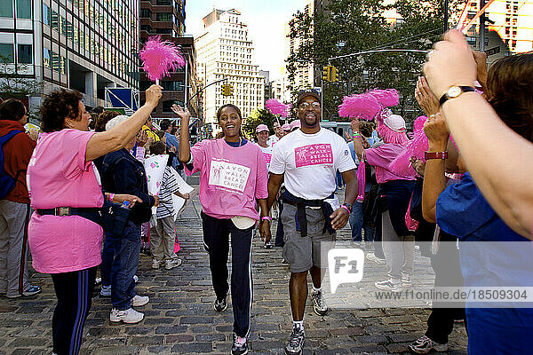 African-American couple gets cheers at the finish of the Avon Walk for Breast Cancer in New York City