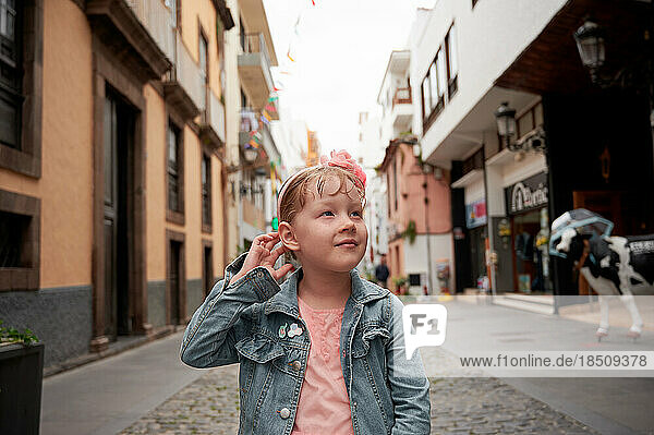 Cute little girl on city street