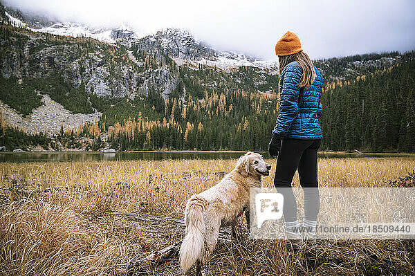 Female hiker and her dog in the north cascade mountains