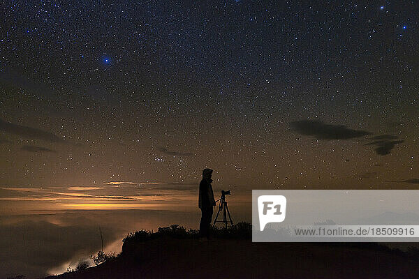 Man photographing the starry sky after sunset