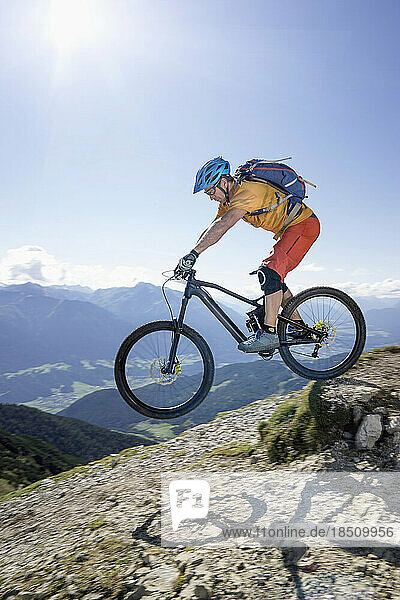 Mountain biker riding downhill  Tirol  Austria