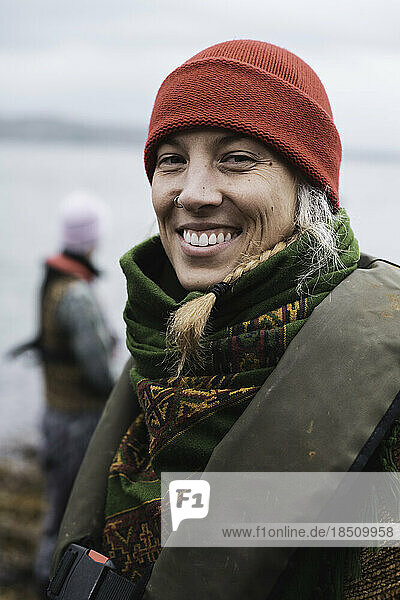 Happy woman smiles with beautiful white teeth on boat jetty
