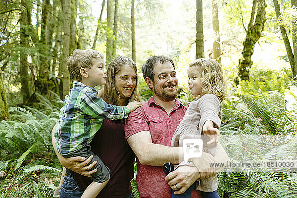 Closeup portrait of a family playing in the forest while on a hike