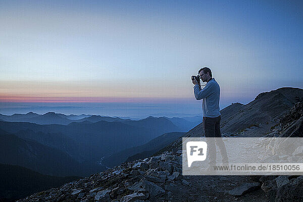 A Man is Taking Pictures of Evening Mountains in Mt. Rainier NP