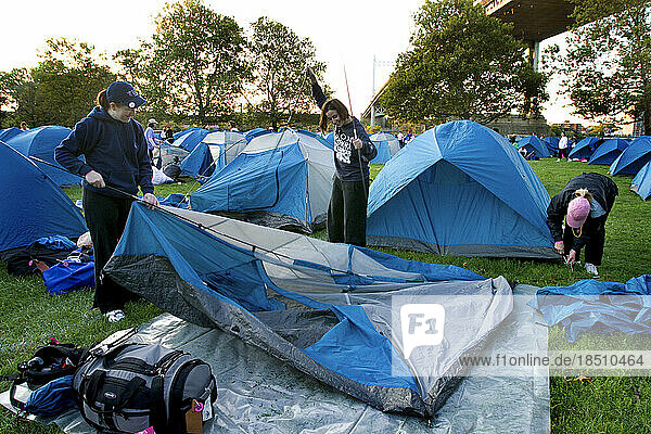 Walkers break down tents after camping overnight during the Avon Walk for Breast Cancer in New York City.