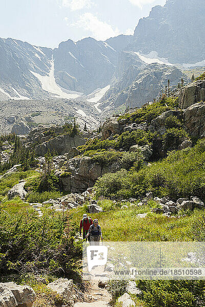 Hikers on trail with mountain views in Rocky Mountain National Park