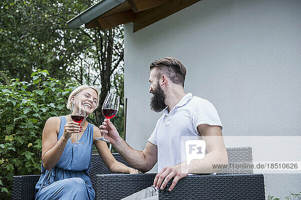 Young couple enjoying red wine in garden  Bavaria  Germany
