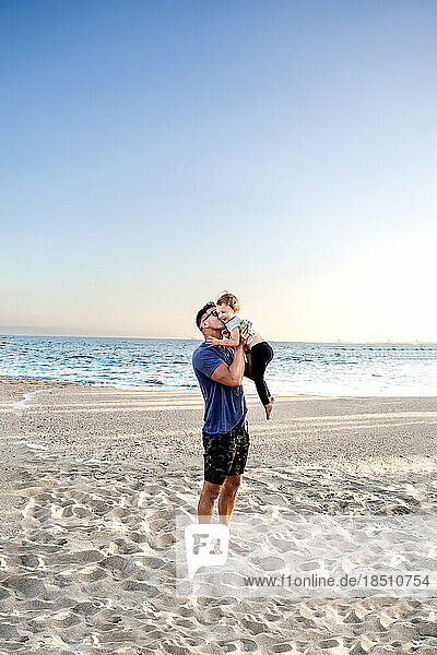 Dad kissing daughter at the beach