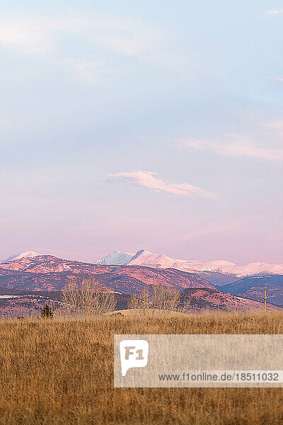 Beautiful Colorado sunrise with snow capped mountains and blue skies