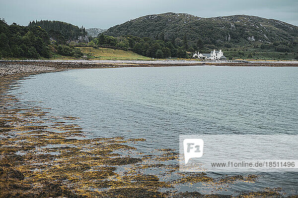 View of beautiful scottish bay and old house with highlands