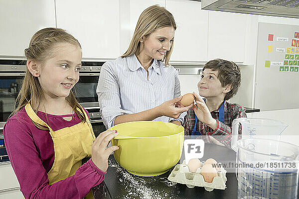 Teacher giving student an egg in home economics class  Bavaria  Germany