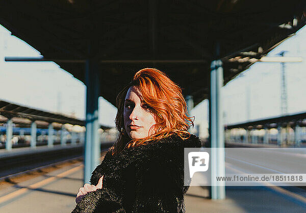 red-haired woman in train station