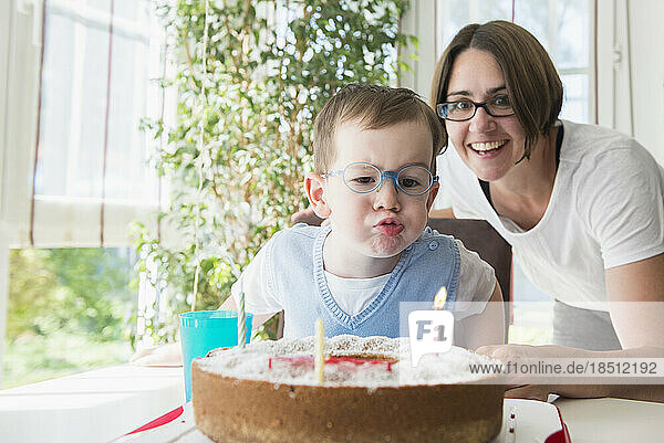 Mother and son blowing birthday candles  Bavaria  Germany