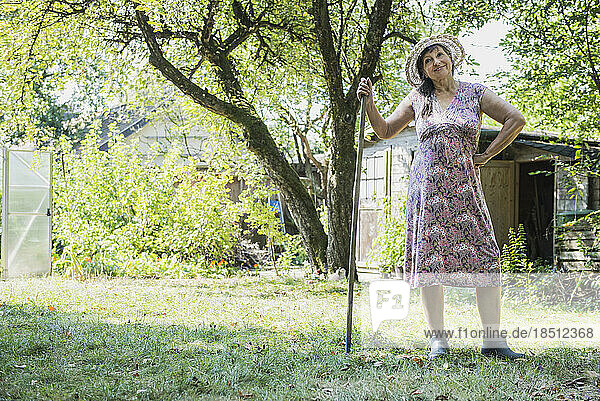Senior woman with a rake in the garden  Altötting  Bavaria  Germany