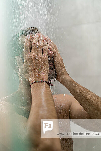 Middle-aged man in the shower  drops of water.