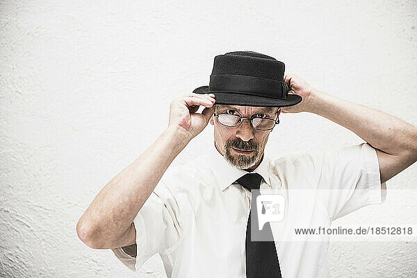 Portrait of a serious mature man wearing a hat  Munich  Bavaria  Germany