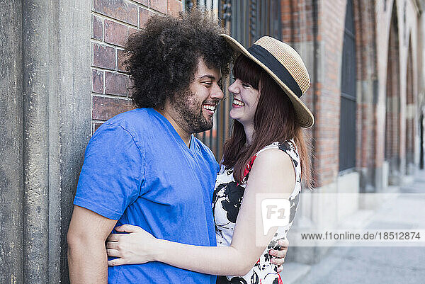 Happy young couple embracing outdoors in city