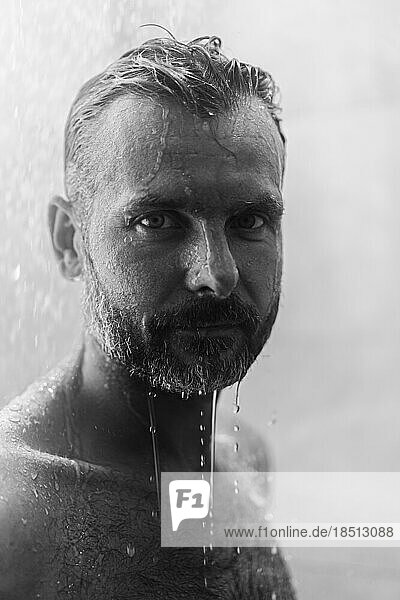 Middle-aged man in the shower  drops of water.