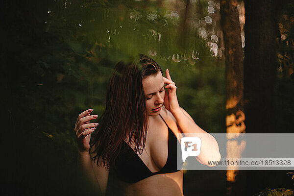 Young sensual woman in forest
