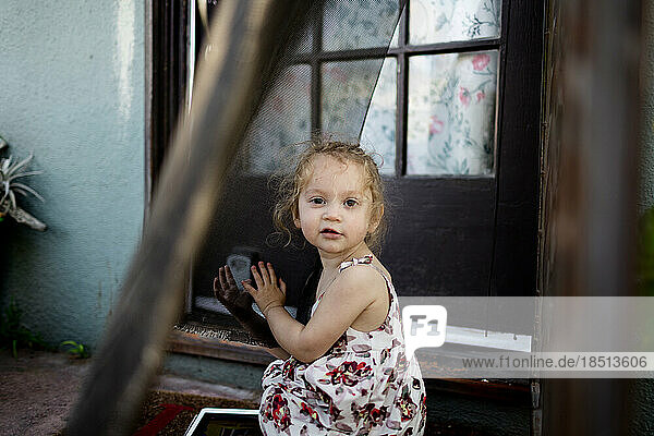 Two Year Old Sitting at Front Door in San Diego