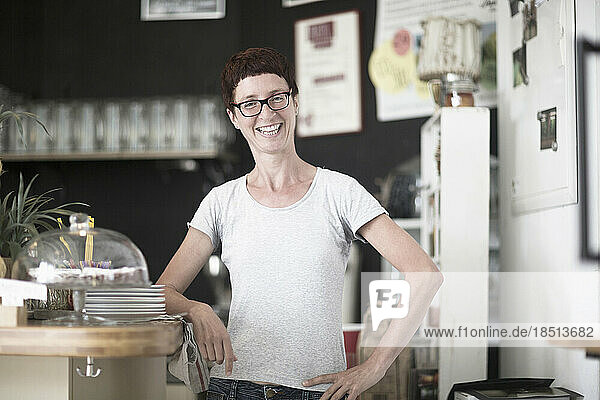 Mature woman standing in the coffee shop and smiling  Freiburg Im Breisgau  Baden-Württemberg  Germany
