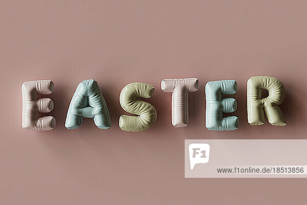 Three dimensional render of inflatable letters spelling word Easter