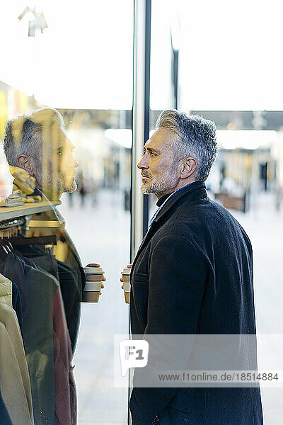 Mature man doing window shopping