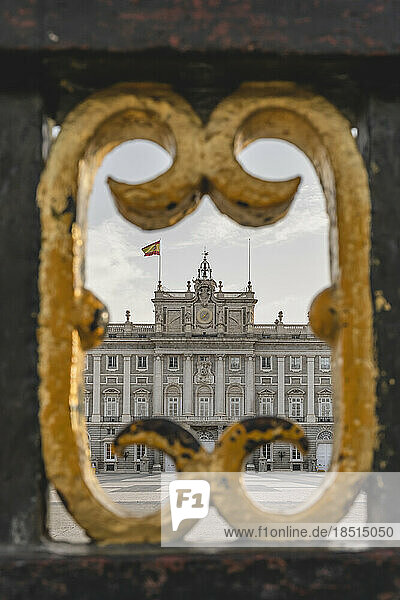 Spain  Madrid  Facade of Madrid Royal Palace seen through bars of main gate