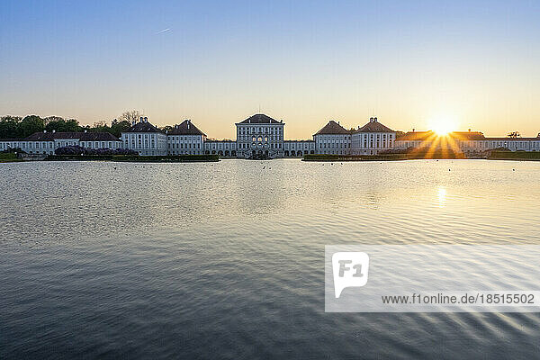 Germany  Bavaria  Munich  Lake in front of Nymphenburg Palace at sunset