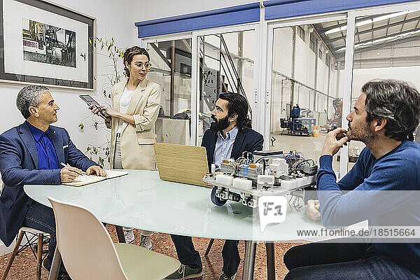 Businesswoman having meeting with colleagues in industry