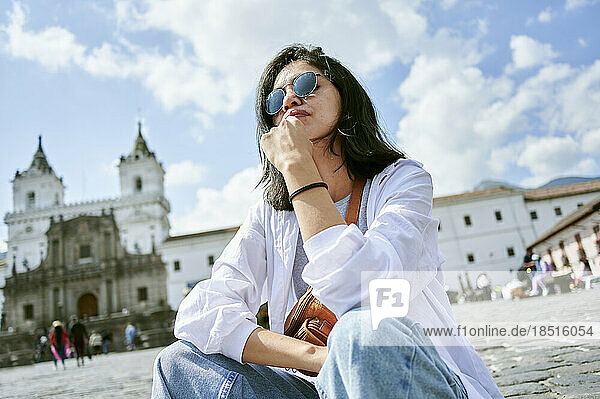 Woman wearing sunglasses with Church and monastery of San Francisco in background