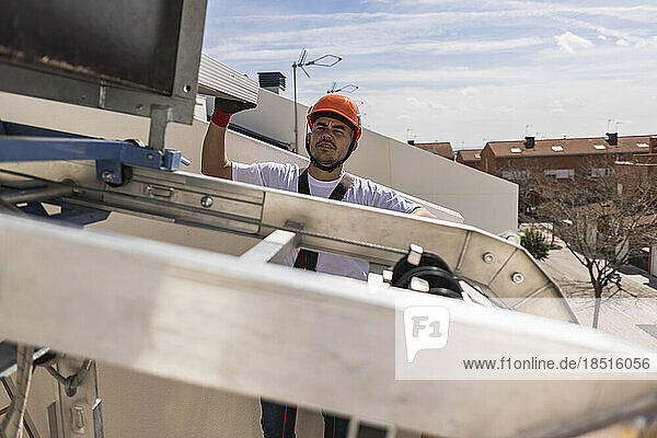 Young engineer working on rooftop