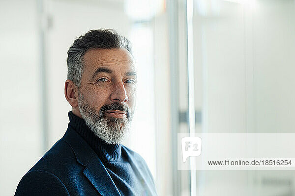 Businessman with gray beard in office