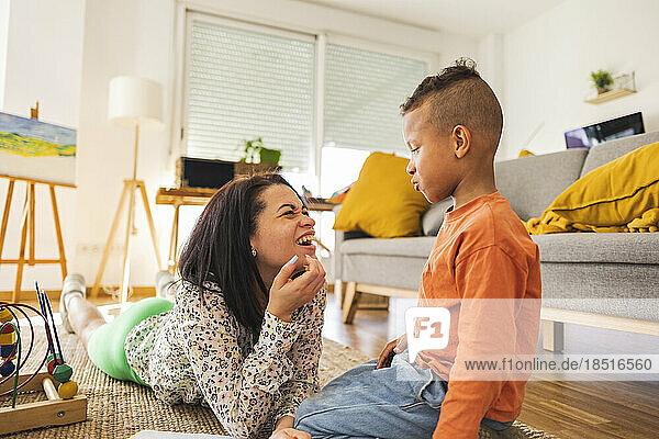 Glückliche Frau  die mit ihrem Sohn spricht und es zu Hause genießt