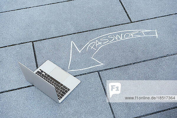 Laptop and password text arrow on road